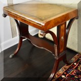 F06. Leather topped side table with shelf. 27”h x 26”w x 19”d 